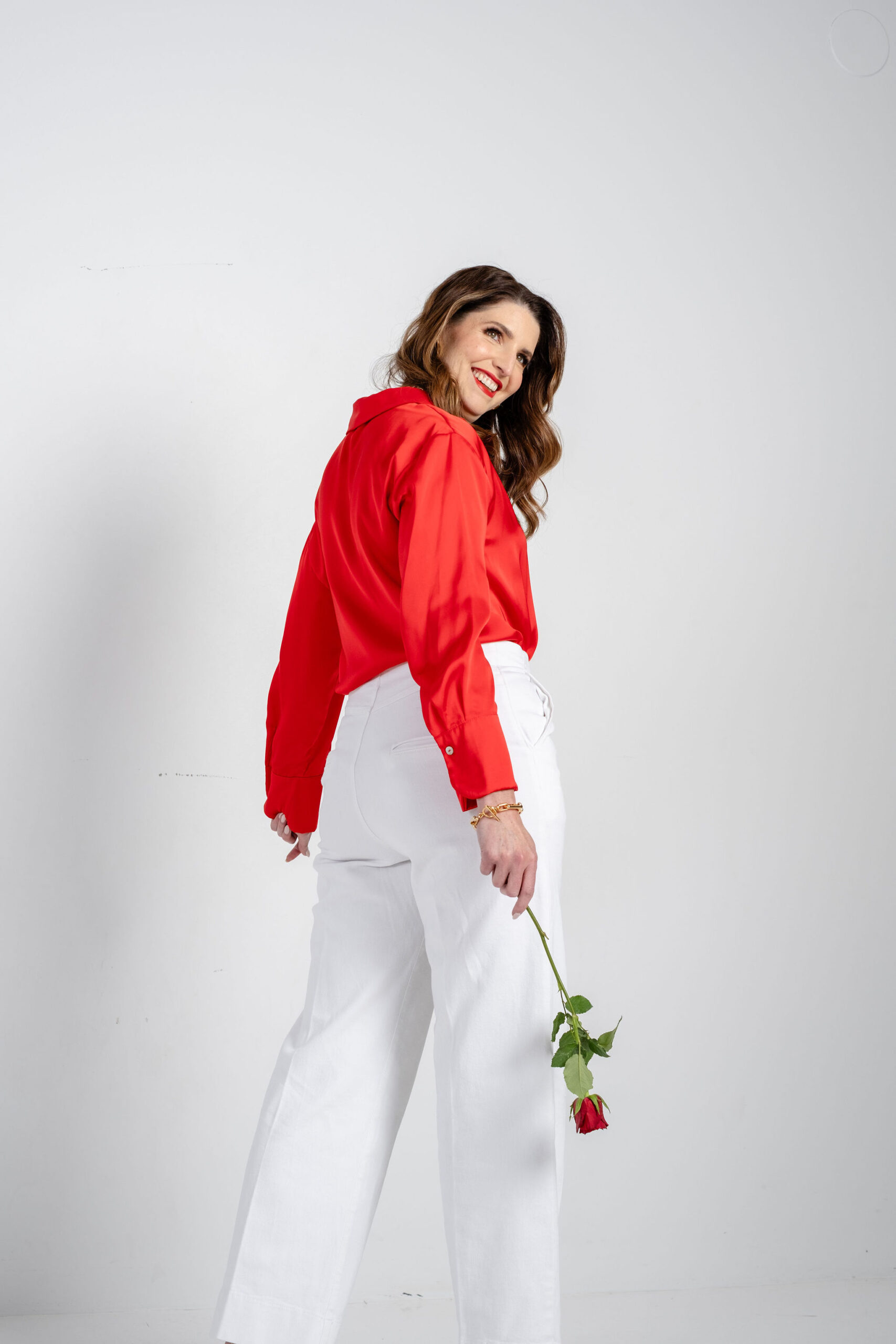 Karen Vivarelli red shirt white pants rose branding photo